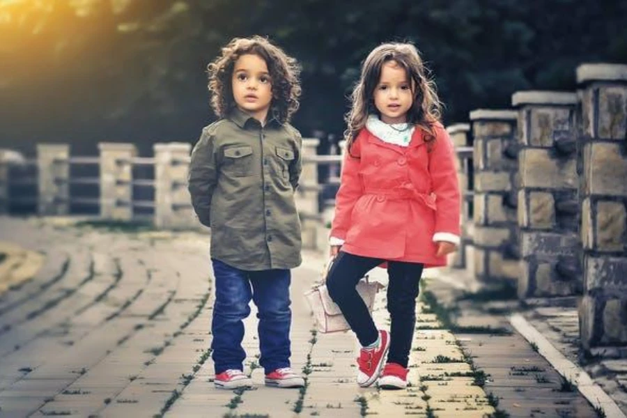 two toddlers wearing red canvas shoes