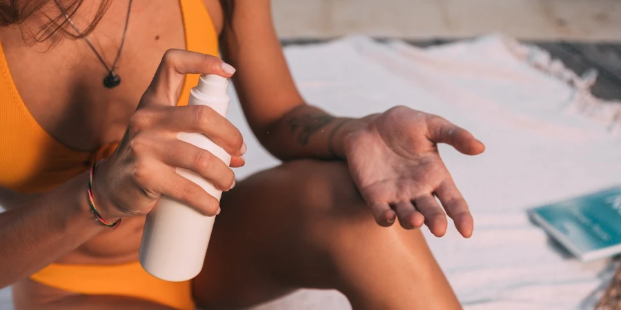 Woman applying sunscreen at the pool