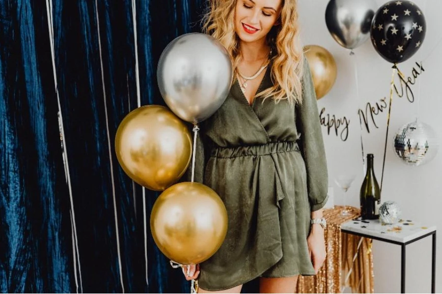 Mulher na festa de ano novo em vestido drapeado verde