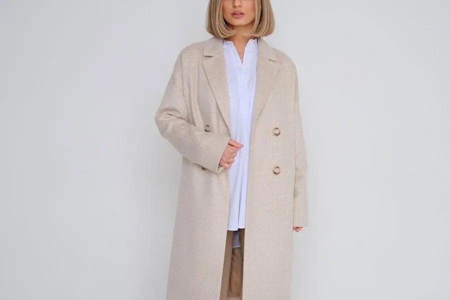 Woman rocking a cream long tailored coat
