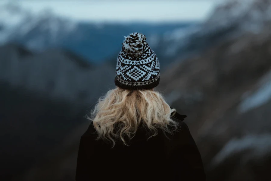 Woman wearing a black and white knit jacquard beanie hat