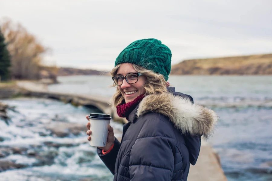 Woman wearing a green knit twisted beanie hat