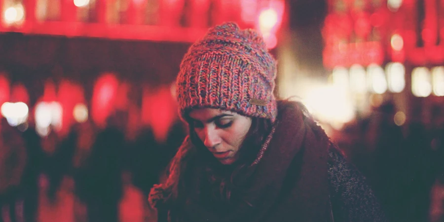 Woman wearing a knit multi-colored cuffless beanie hat