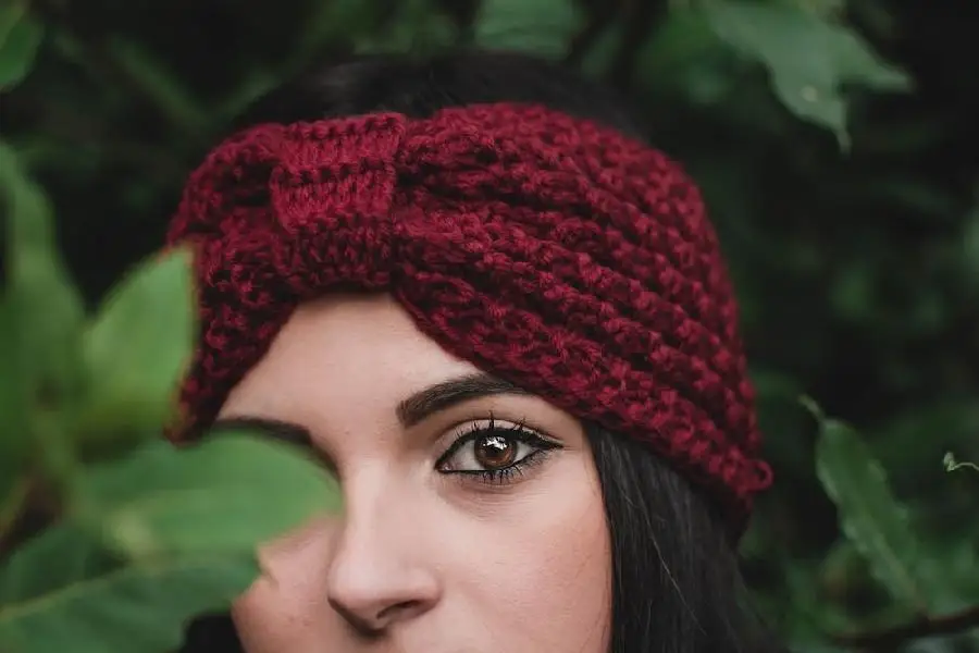 Woman wearing a red knitted winter headband