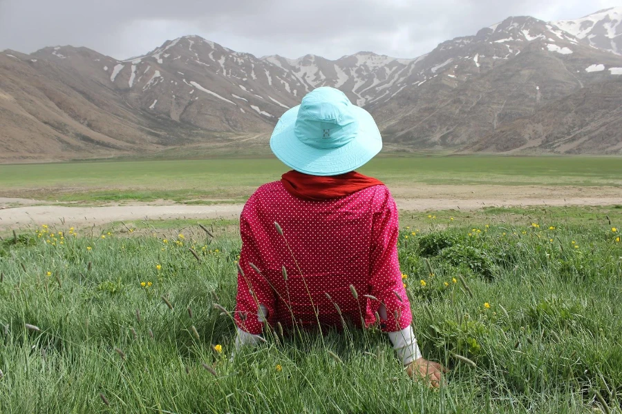 Woman with a red scarf rocking a blue bucket hat