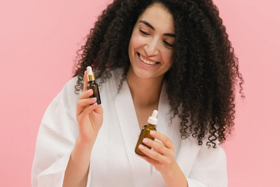 Woman with curly hair holding cosmetic products