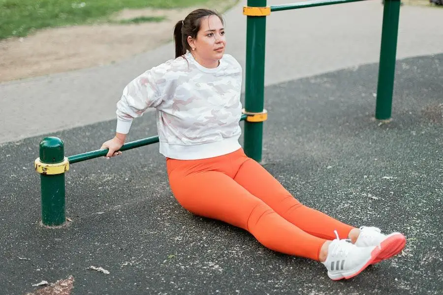 Woman working out in orange leggings