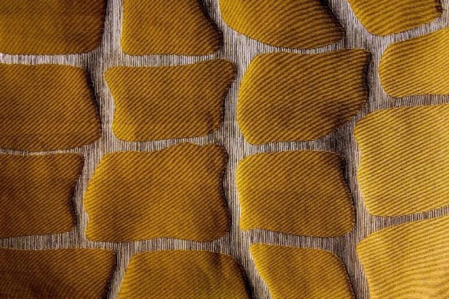 Yellow textile with raised organic shapes