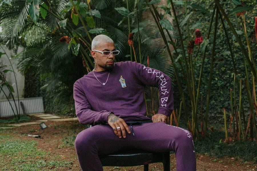 Young man posing in a stylish purple tracksuit