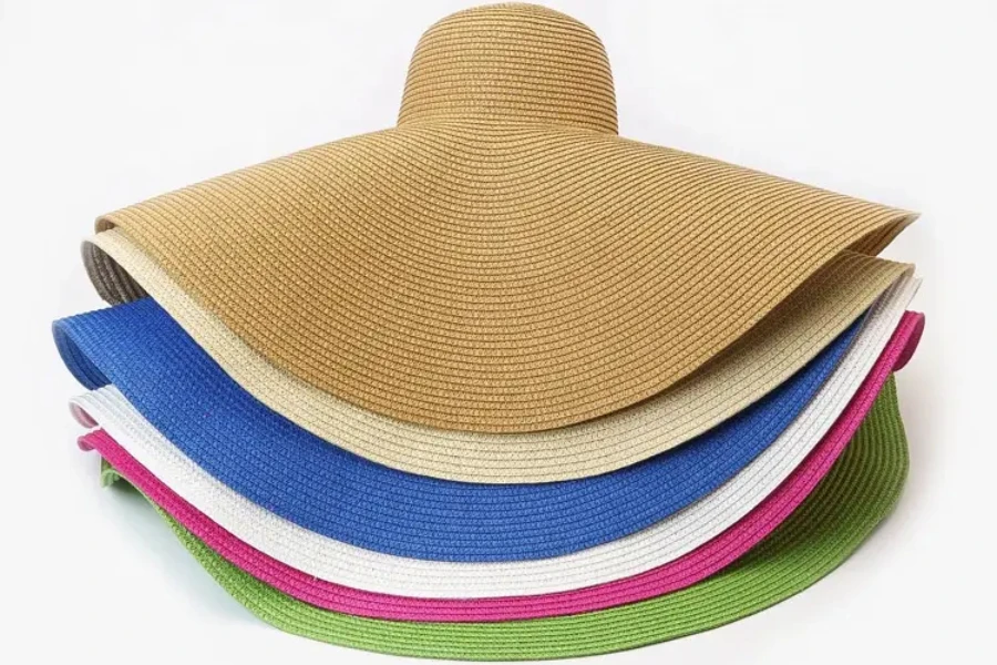 A bunch of paper straw hats stacked together