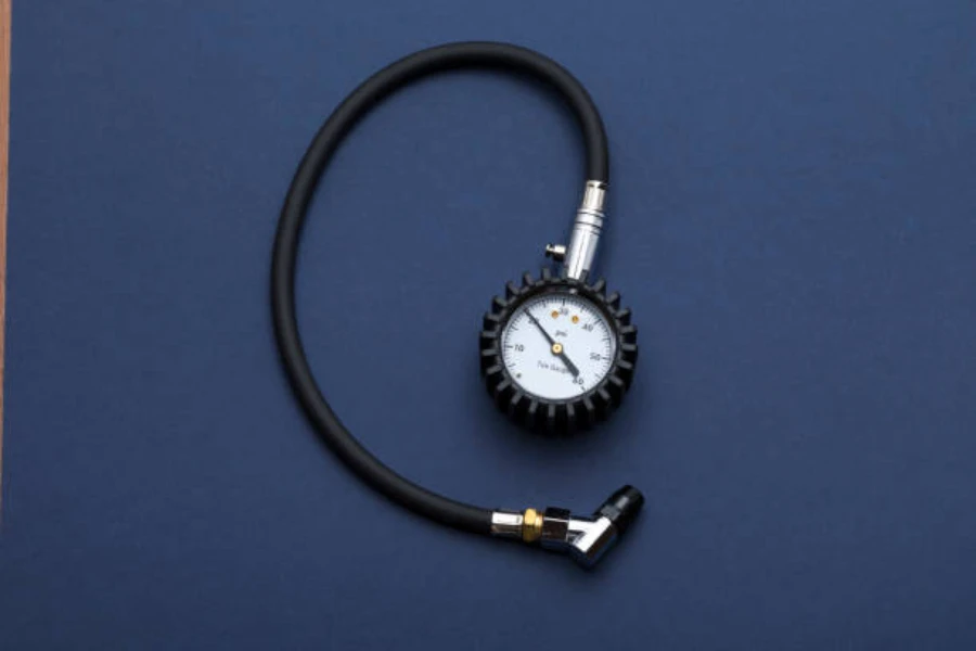 A car tire pressure gauge on a dark-blue background