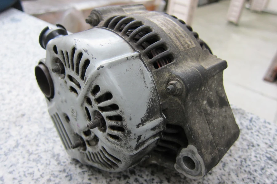 A detached car alternator ready for replacement