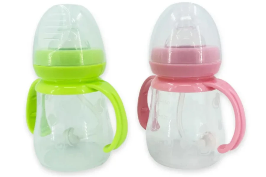 A lemon green and a pink wide-neck baby bottle
