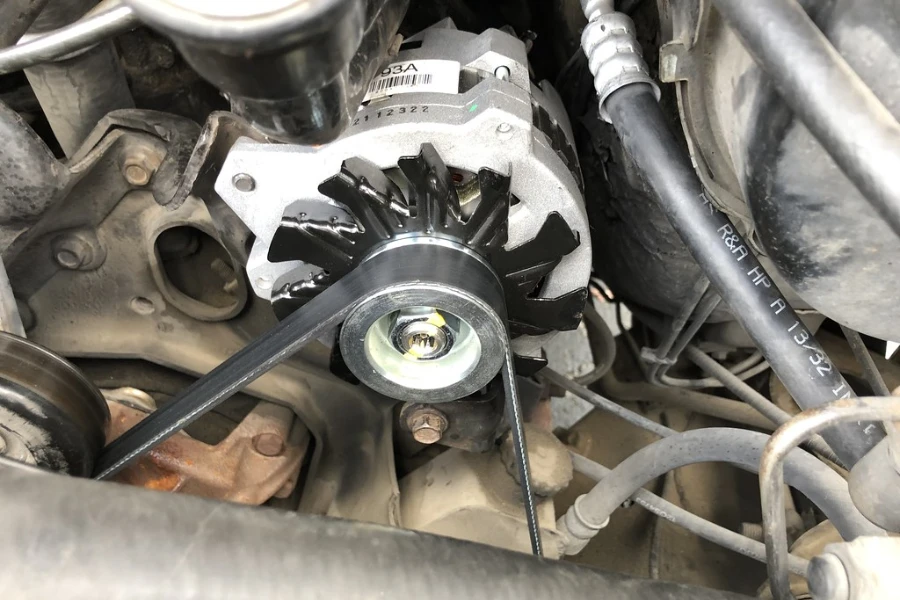 A new alternator installed in an old engine setup