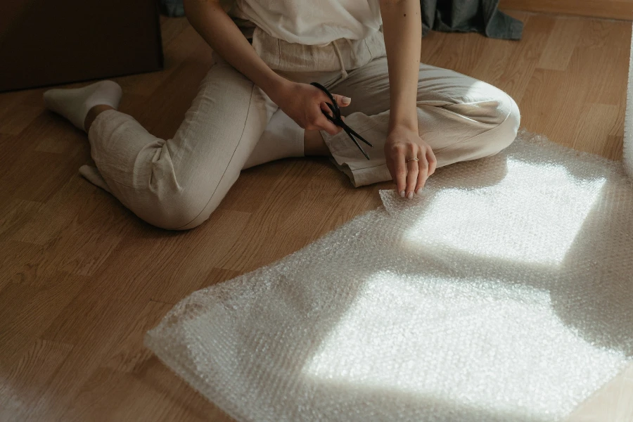 A person cutting plastic wrapping