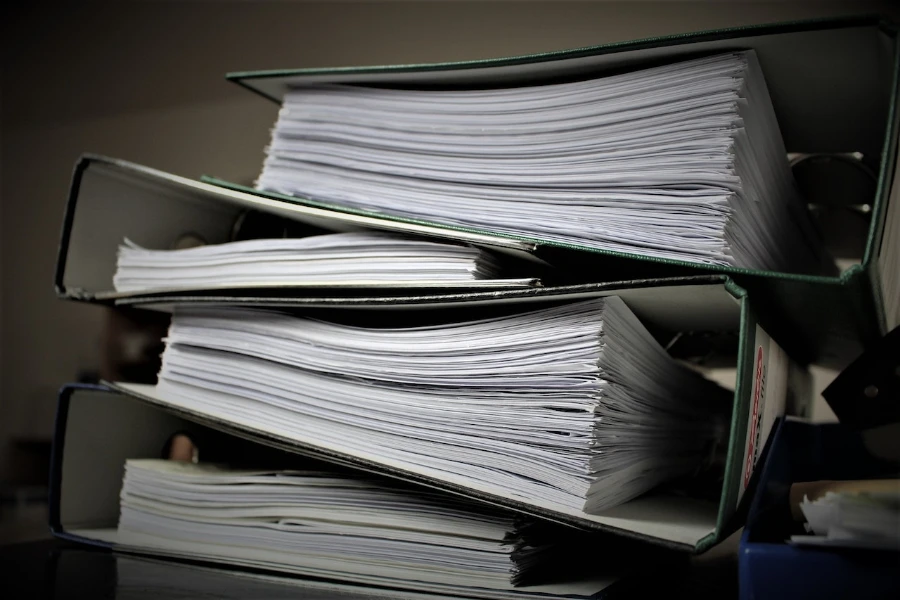 A photo displaying a pile of folders