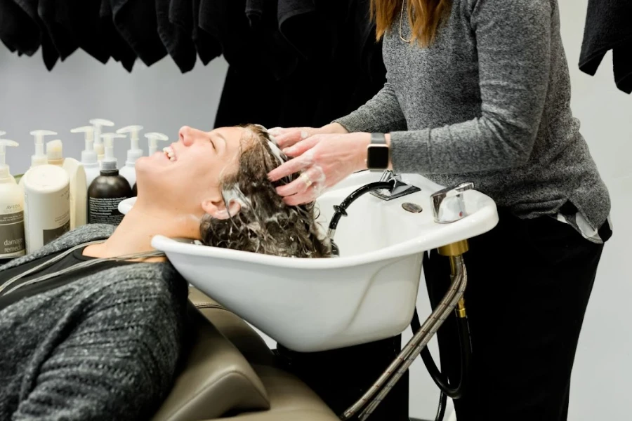 A woman getting her hair washed