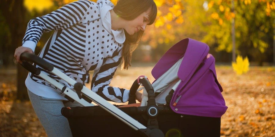 A woman using a big baby stroller