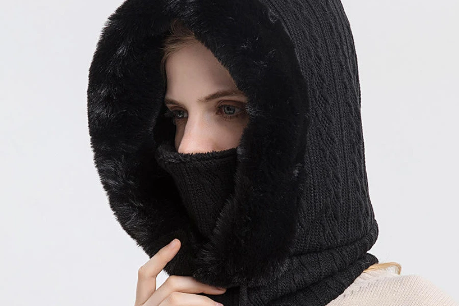 A woman wearing a black knit one-hole balaclava