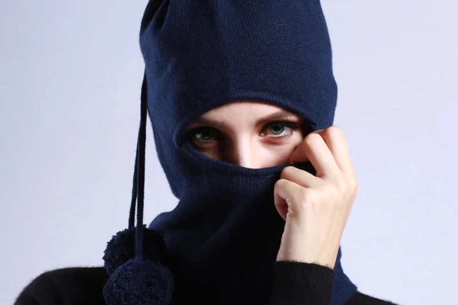 A woman wearing a knit navy blue one-hole balaclava