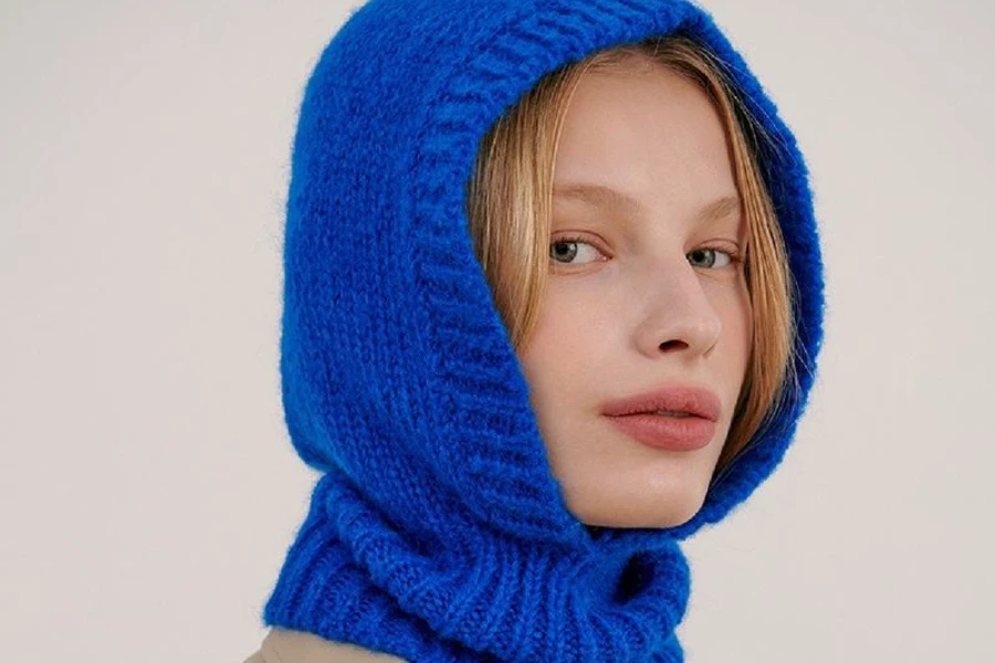A woman wearing a royal blue one-hole hood balaclava
