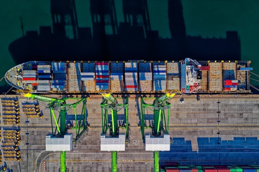 Aerial view of a cargo ship sitting at the dock in a port