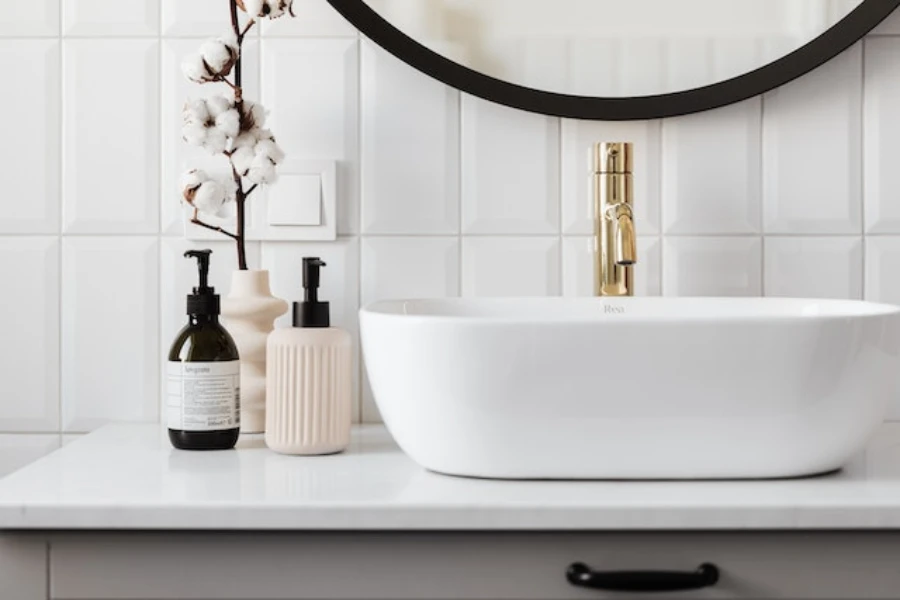 Bathroom interior with a gold faucet in a white basin