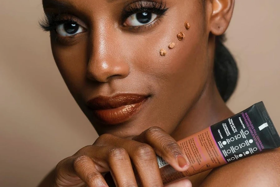 Black woman showcasing multi-shade beauty product