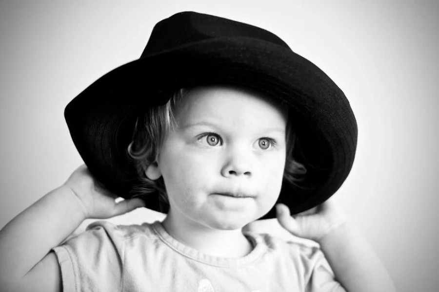 Boy wearing black wide brim bucket hat
