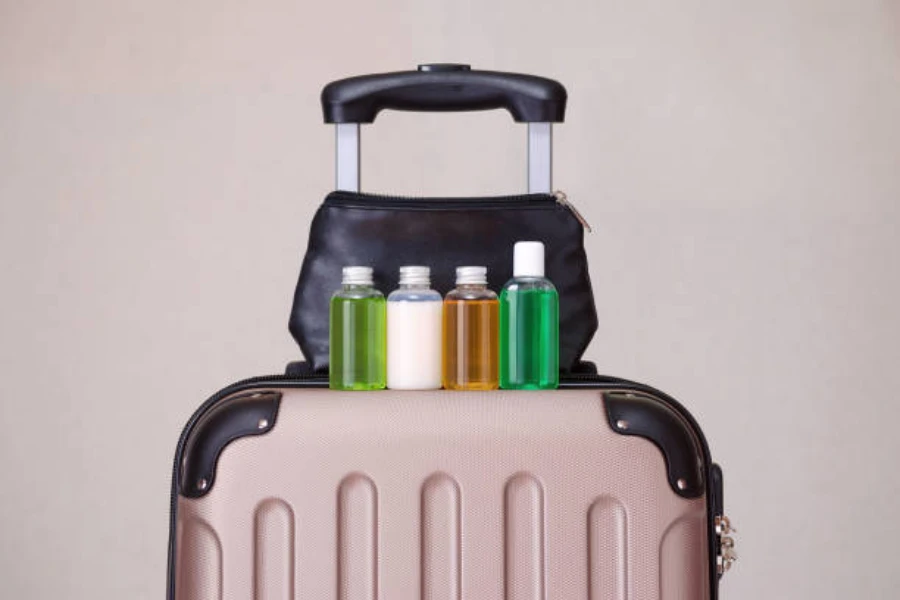 Brown suitcase with mini shampoo bottles sitting on top