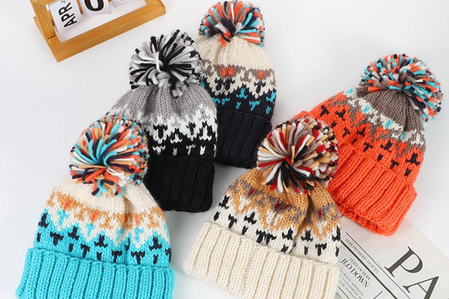 Collection of multi-colored pom-pom beanies