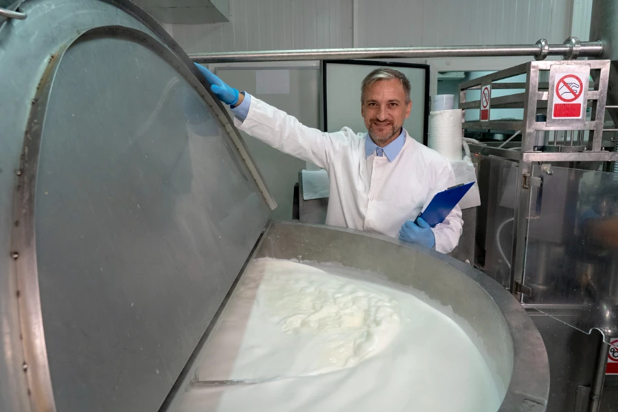 Tecnólogo de alimentos de plantas lecheras revisando el proceso de pasteurización de leche