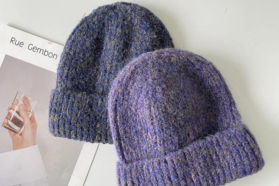 Display of two purple wide-cuff beanies