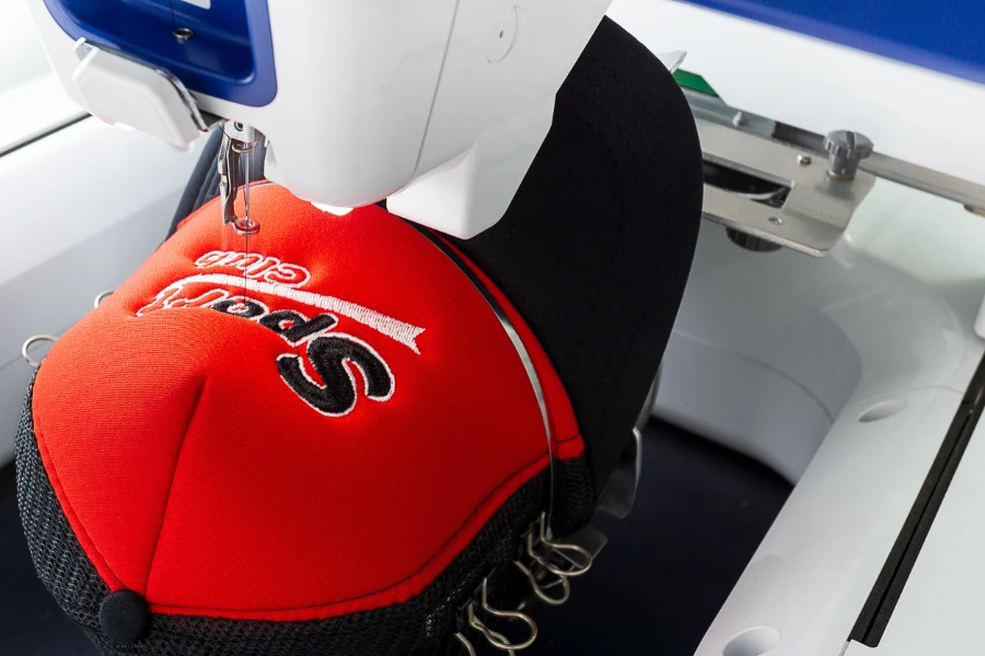 Embroidery machine sewing a logo on a cap