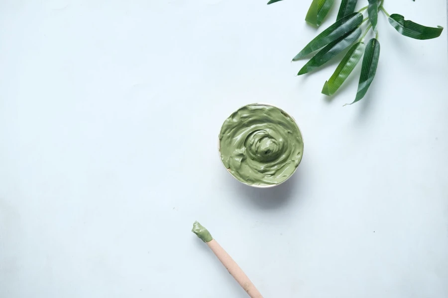 Green skincare mask with applicator