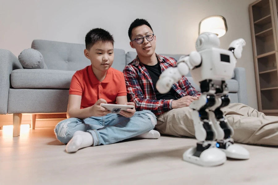 Man and boy controlling a robot via a mobile app