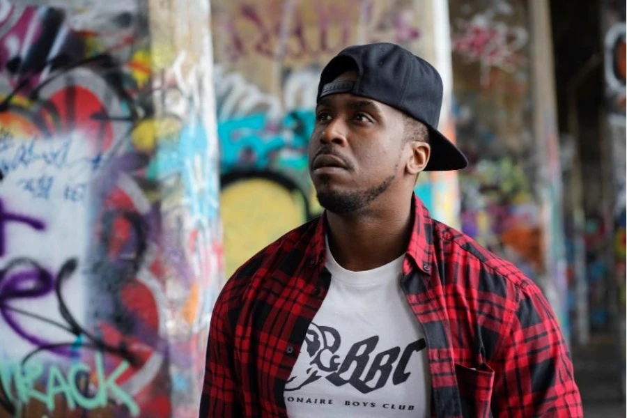 Man in black baseball cap with snapback