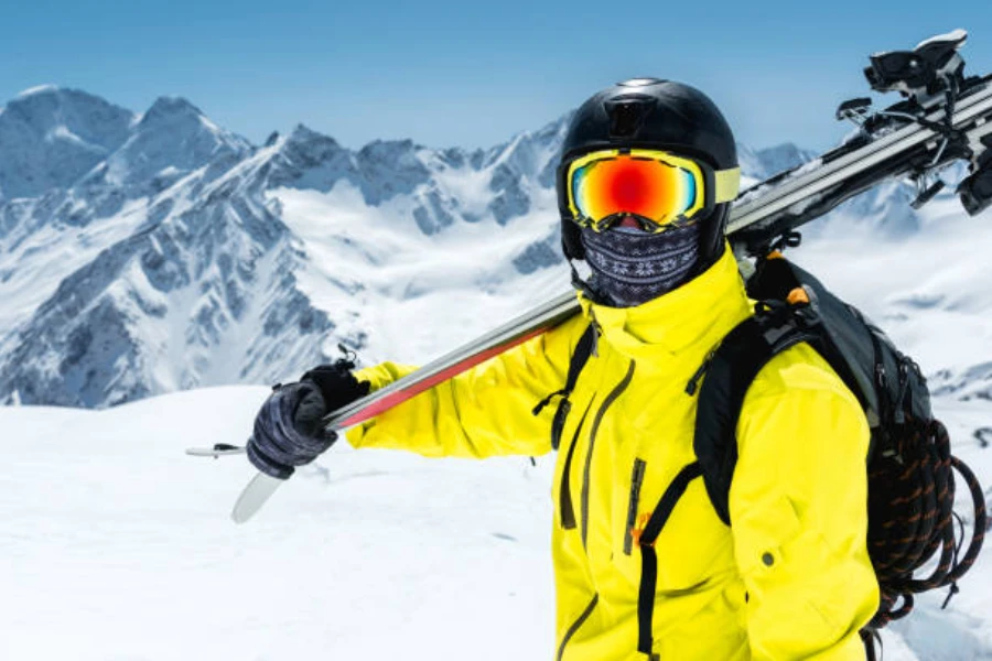 Man on slopes with skis and patterned neck warmer