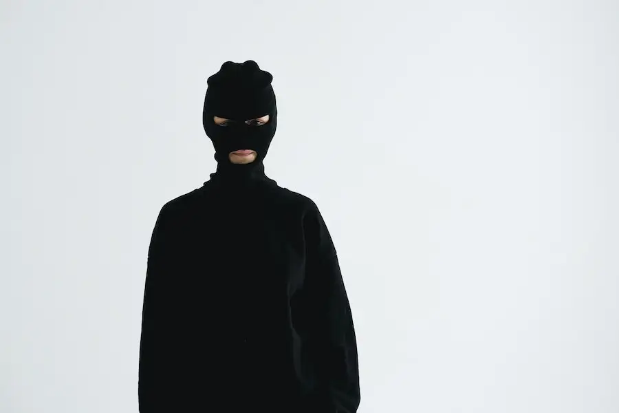 Man posing in a black base layer with detachable balaclava