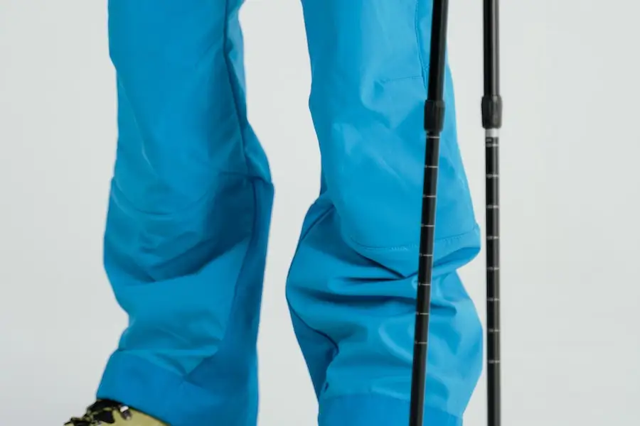 Man wearing blue adaptable ski pants