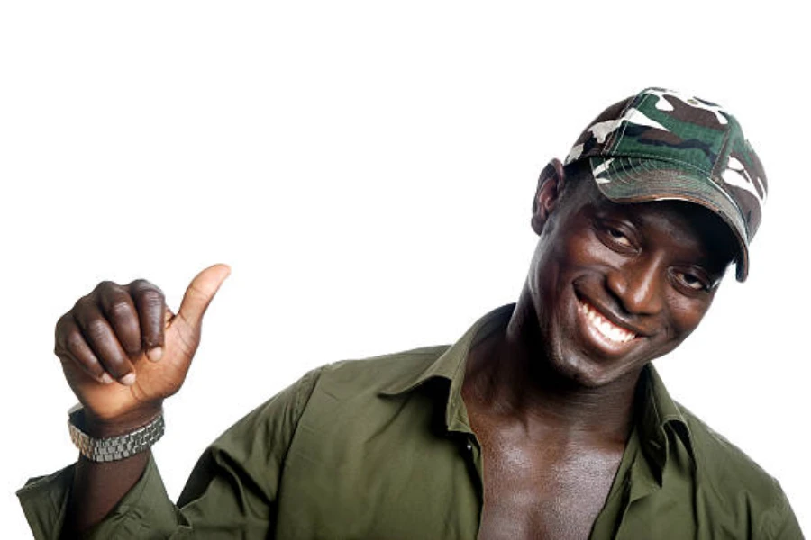 Man wearing dark camouflage baseball cap and green shirt