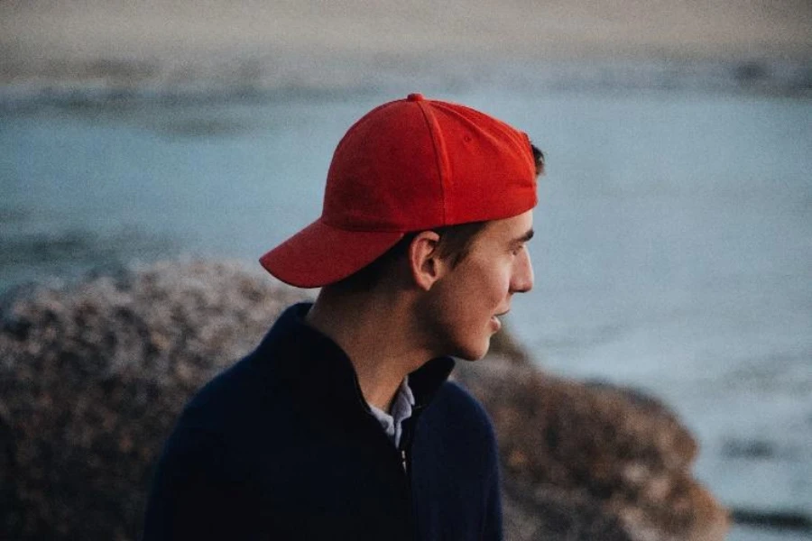 Man wearing red cotton ball cap