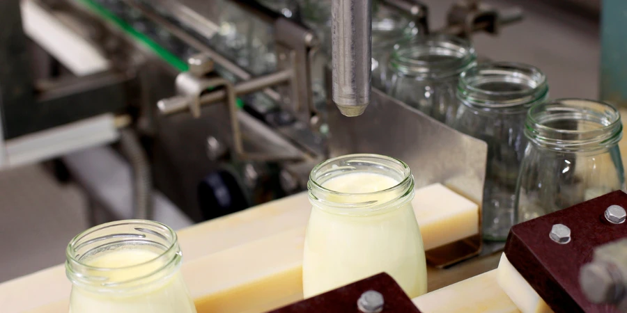 Milk bottles filling up in a milk processing plant