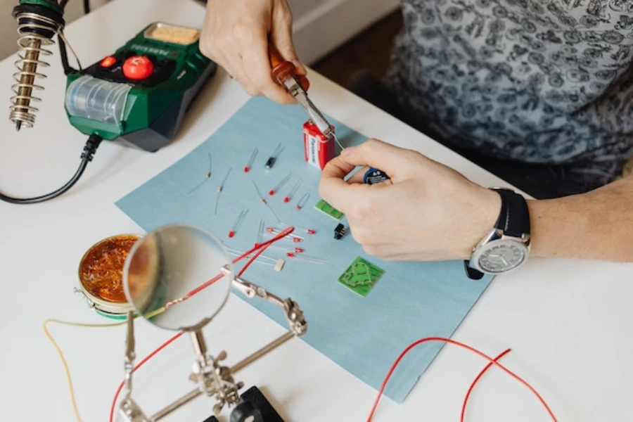 Person holding a cable string for soldering