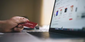 Person holding a credit card shopping online