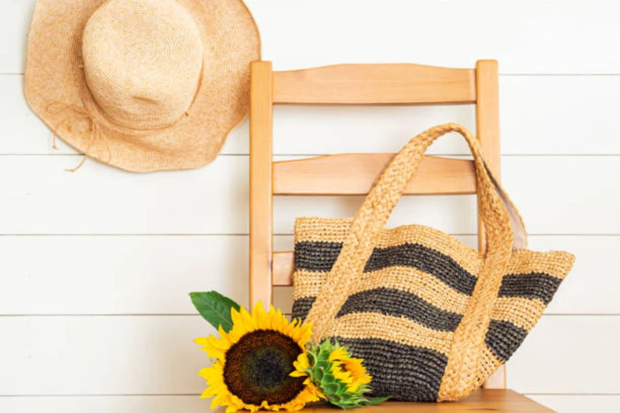 Raffia hat hung on wall next to matching tote bag