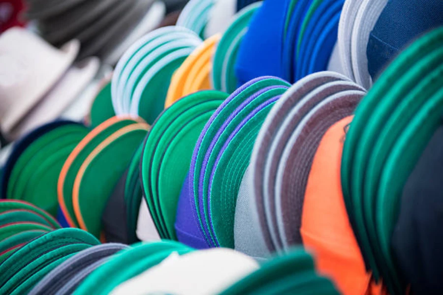 Selection of baseball caps stacked up with the brim showing