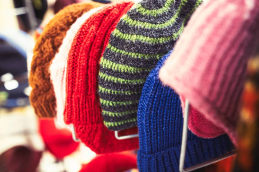 Selection of colorful cotton beanies hung up in shop