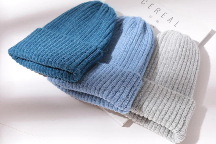 Selection of gray, aqua, and light blue cuffed beanies