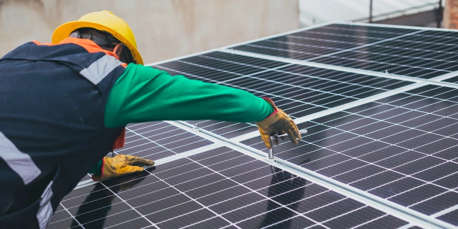 Solar technician installing solar panel